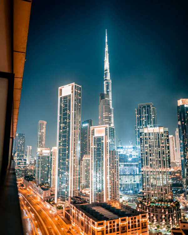 Burj Khalifa and Downtown Dubai towers glowing at night